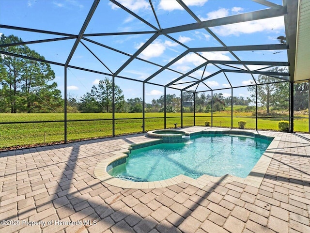 view of pool with a lanai, a patio, an in ground hot tub, and a yard