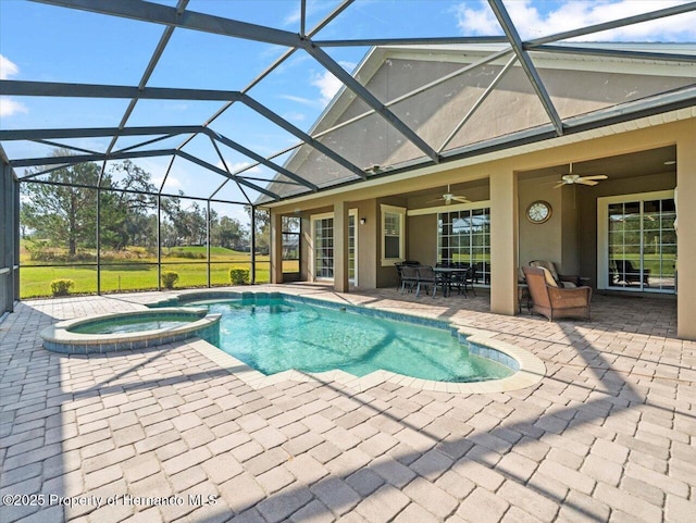 view of pool featuring glass enclosure, an in ground hot tub, and a patio area