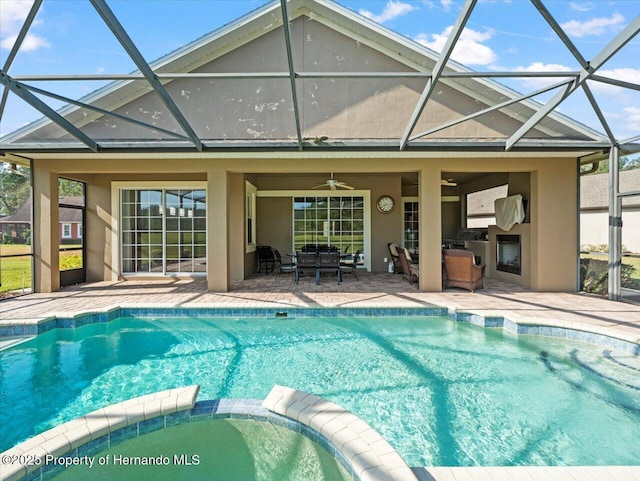 view of swimming pool featuring ceiling fan, a patio, and an in ground hot tub