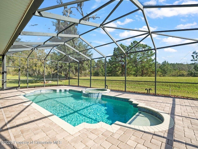 view of pool featuring a patio area, glass enclosure, a yard, and an in ground hot tub