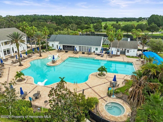 view of swimming pool featuring a patio area and a hot tub