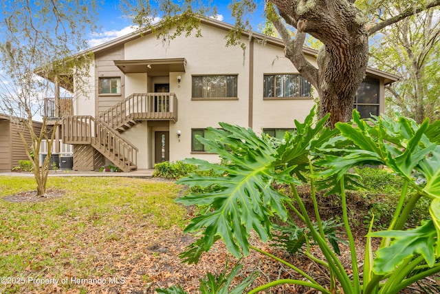 back of property featuring central AC unit