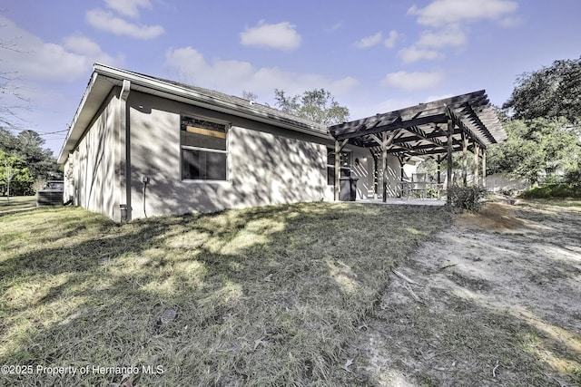 back of property featuring a patio, a lawn, and a pergola