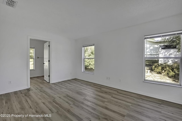 spare room featuring light wood-type flooring