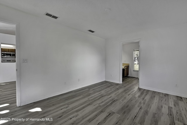 unfurnished room with hardwood / wood-style floors