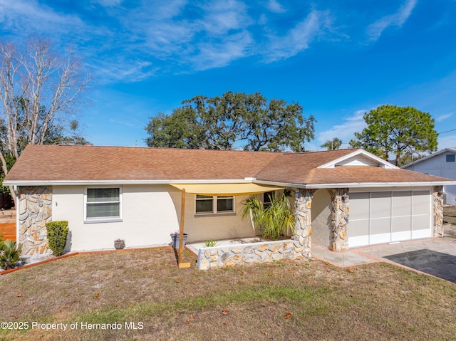 single story home featuring a front lawn and a garage