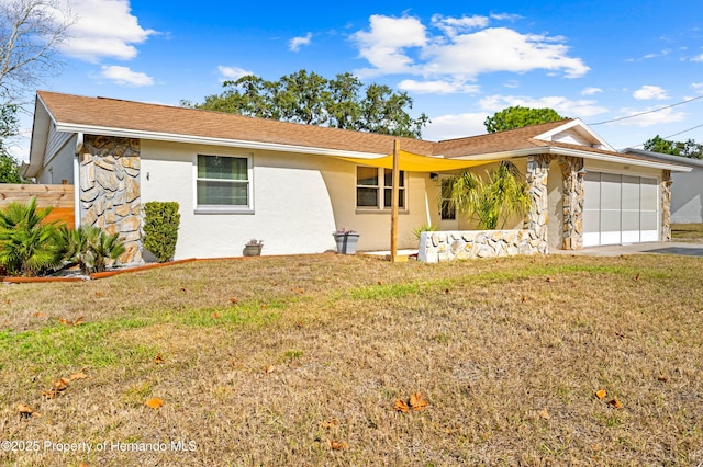 single story home with a front lawn and a garage