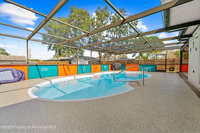 view of swimming pool with a lanai and a patio