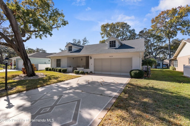 view of front of property featuring a garage and a front lawn