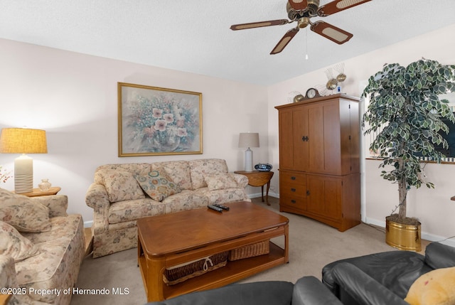 living room featuring ceiling fan, light colored carpet, and a textured ceiling