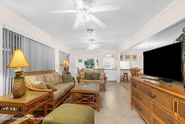 living room with ceiling fan and light tile patterned floors