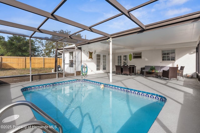 view of pool featuring glass enclosure, french doors, and a patio