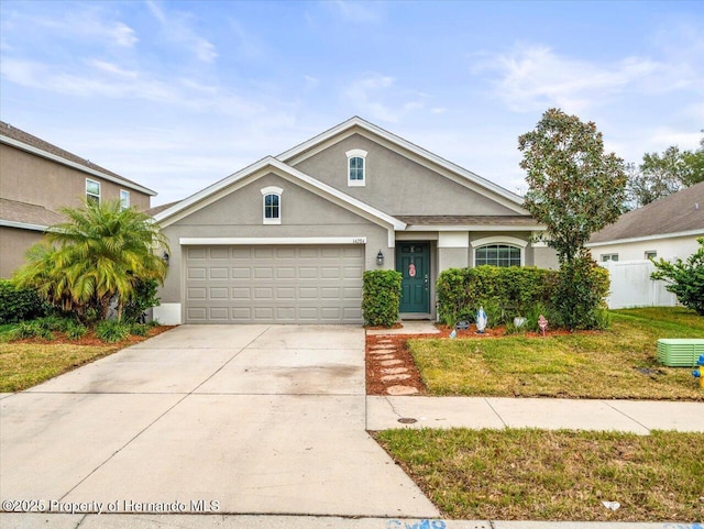 view of front of property featuring a garage and a front lawn