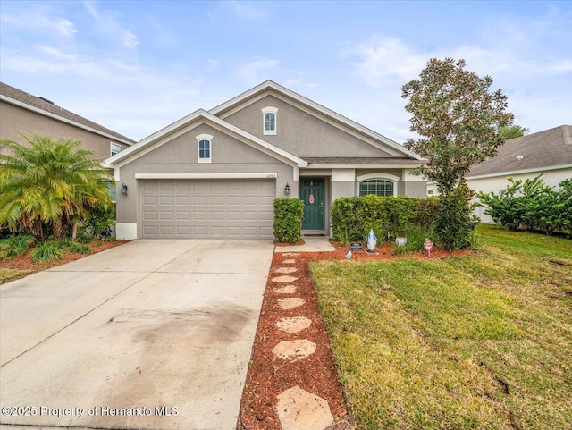 view of front of property with a garage and a front yard