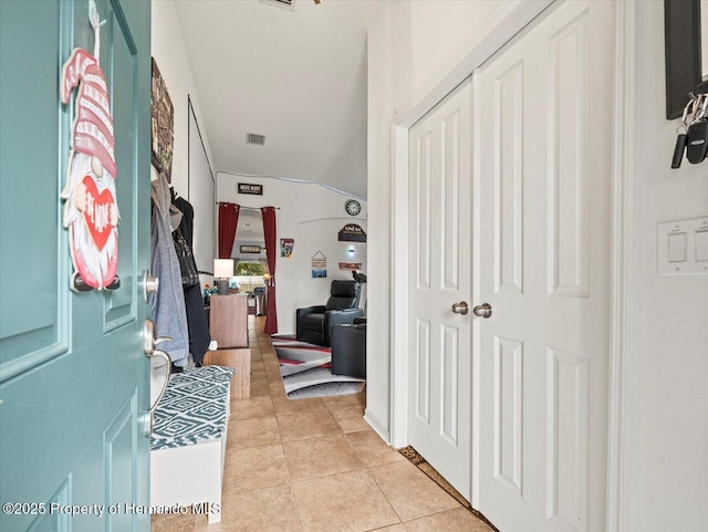 mudroom featuring light tile patterned floors and lofted ceiling