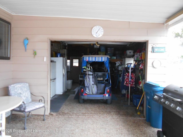 garage featuring white fridge