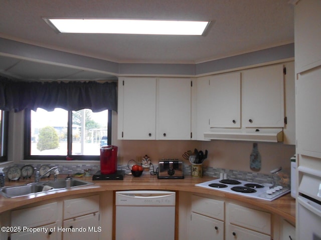 kitchen featuring white appliances, white cabinets, and sink