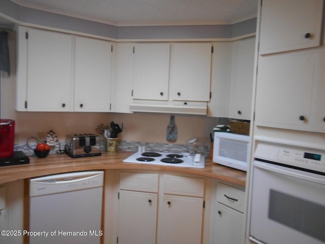 kitchen with white appliances, wooden counters, and white cabinetry