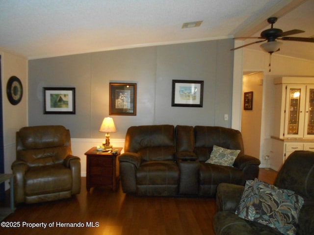 living room with lofted ceiling, ceiling fan, and dark hardwood / wood-style floors