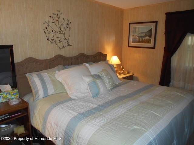 bedroom with wood walls