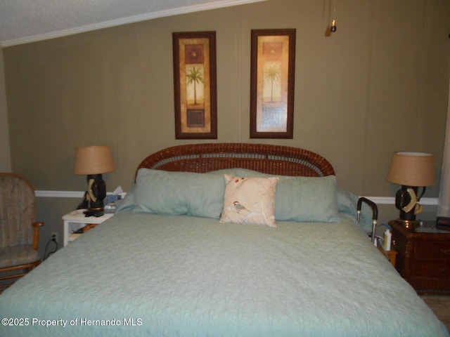 bedroom with vaulted ceiling and crown molding