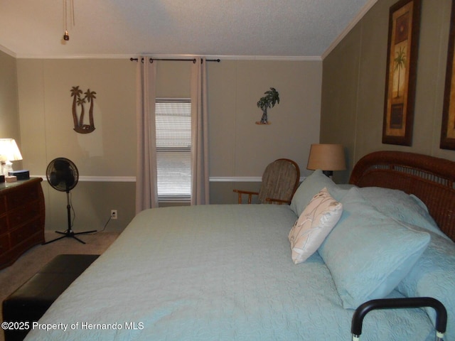 bedroom featuring carpet flooring, a textured ceiling, and crown molding