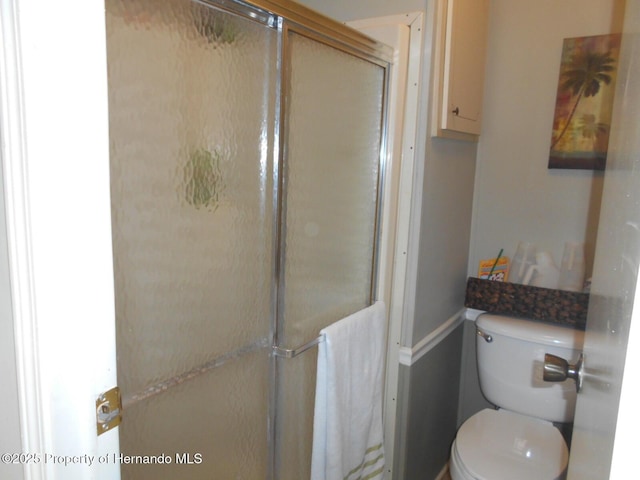 bathroom with walk in shower and toilet