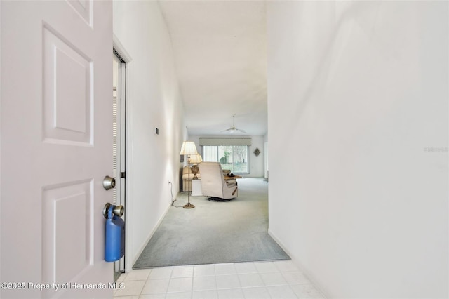 hallway featuring light carpet