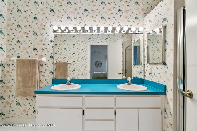 bathroom featuring a shower with shower door and vanity