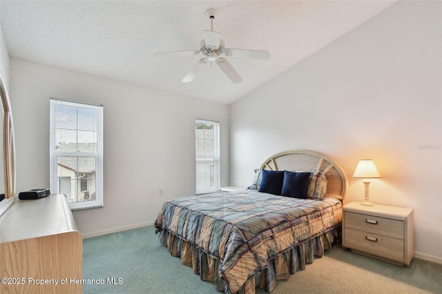 carpeted bedroom featuring lofted ceiling, ceiling fan, and multiple windows