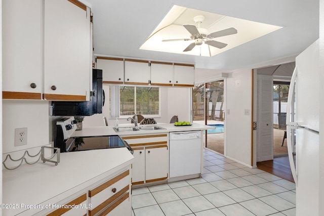 kitchen with white cabinetry, sink, white appliances, and plenty of natural light