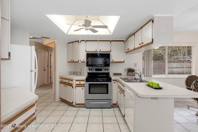 kitchen with white appliances, white cabinetry, sink, kitchen peninsula, and ceiling fan