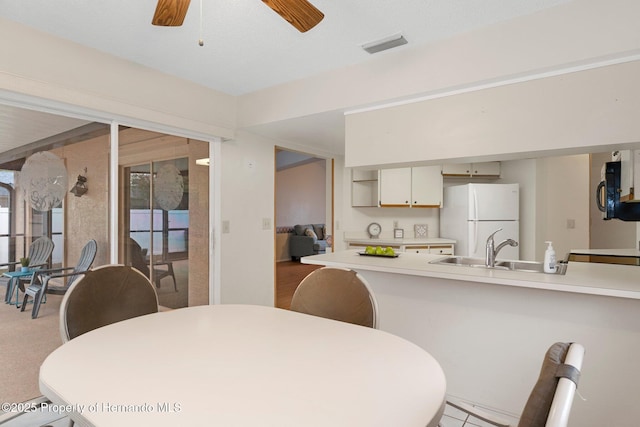 dining room with sink and ceiling fan