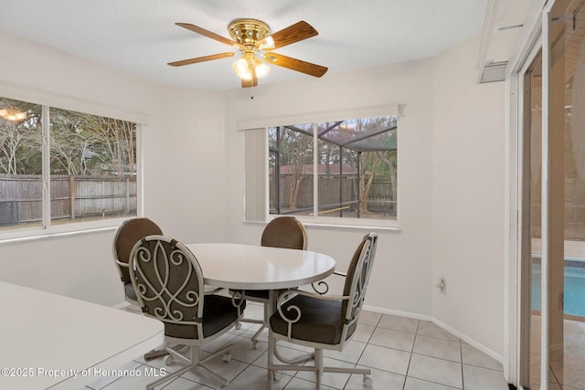 tiled dining room with ceiling fan