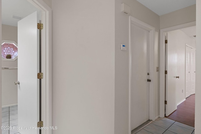 corridor featuring light tile patterned floors