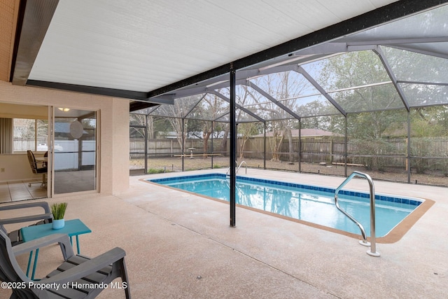 view of swimming pool with glass enclosure and a patio area