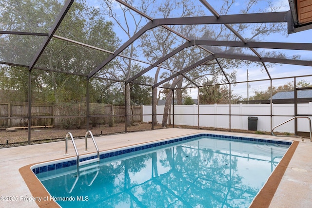 view of swimming pool with a lanai and a patio