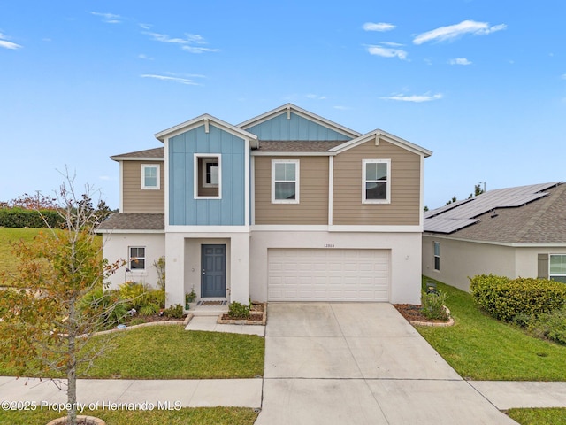 view of front facade featuring a front yard and a garage