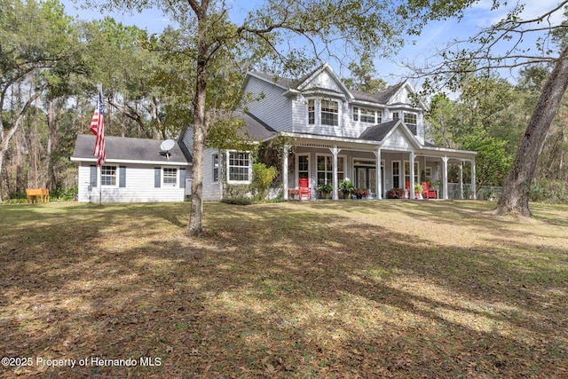 view of front of house with a front yard and a porch