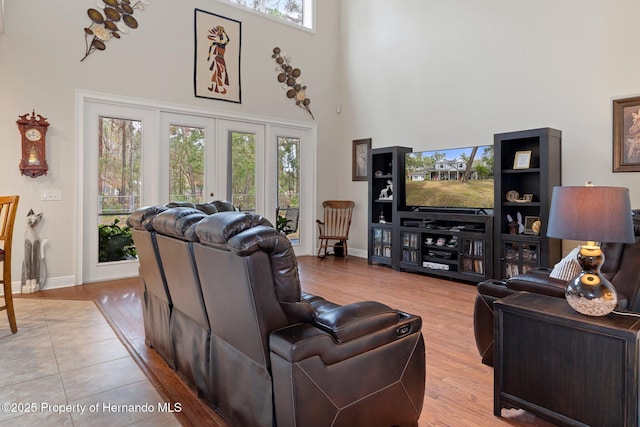 living room featuring a high ceiling and light wood-type flooring