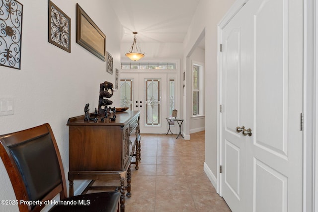 tiled foyer featuring french doors