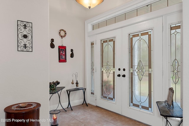 foyer with light tile patterned floors and french doors