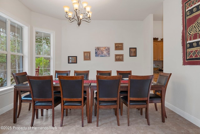 dining space with a notable chandelier and light tile patterned floors