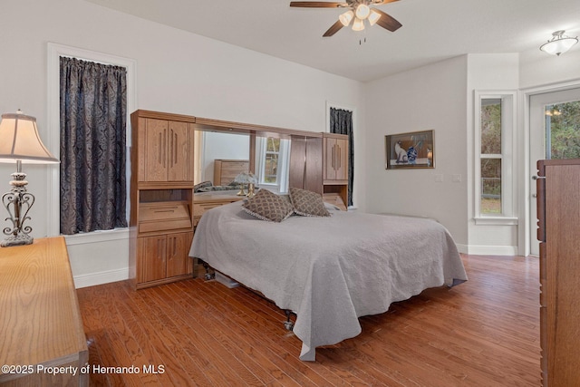 bedroom with ceiling fan and hardwood / wood-style flooring