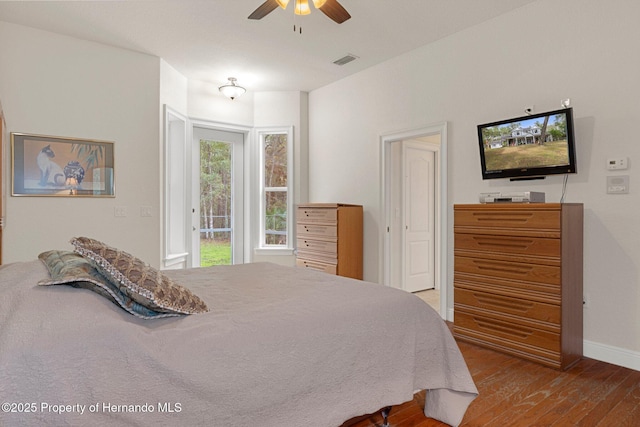 bedroom featuring hardwood / wood-style floors, access to exterior, and ceiling fan