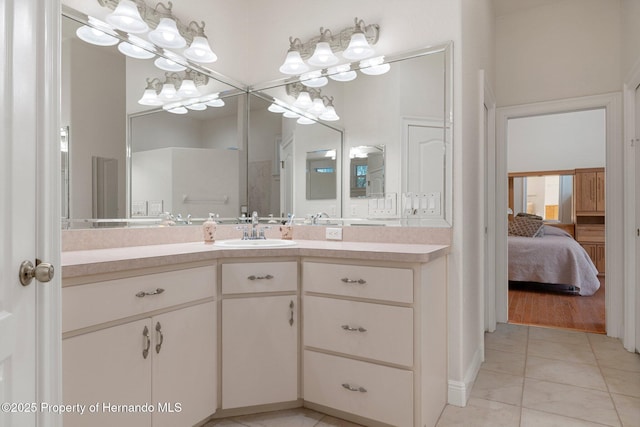 bathroom featuring vanity, walk in shower, and tile patterned flooring