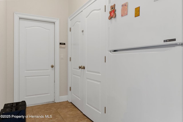 doorway to outside featuring light tile patterned flooring