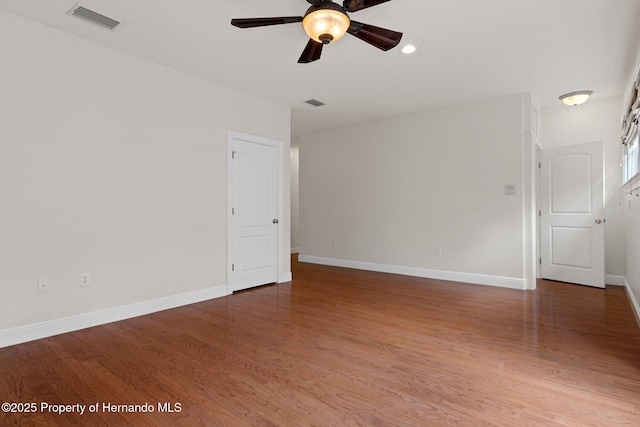 spare room featuring hardwood / wood-style flooring and ceiling fan