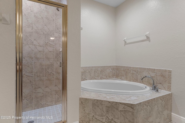 bathroom featuring shower with separate bathtub