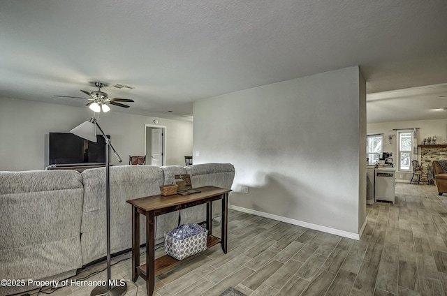 living room with ceiling fan and light hardwood / wood-style floors